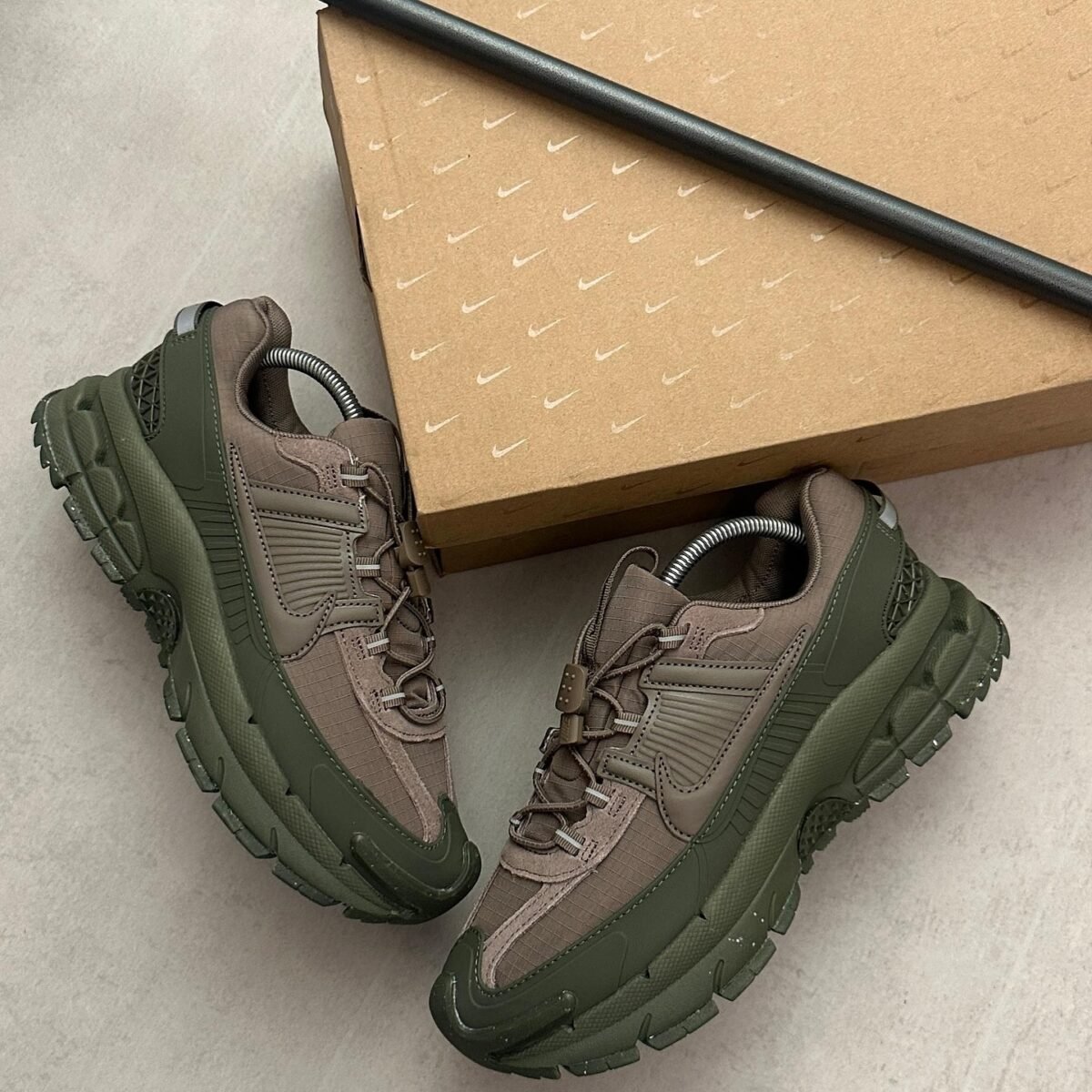 Sneakers in a vibrant olive green color, featuring a unique design and a comfortable fit. The brand is known for its high-quality products and excellent customer service.