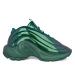 Sneakers in a vibrant teal color, designed with a sleek, modern aesthetic. Featuring a unique curved design and high-quality materials.