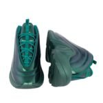 Sneakers in a vibrant teal color, designed with a sleek, modern aesthetic. Featuring a unique curved design and high-quality materials.