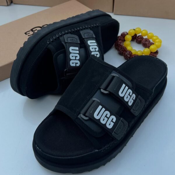 Sneakers, loafers, and slip-ons in black, perfect for any Nigerian wardrobe. Ugg's signature 'UGG' is featured on the straps, adding a touch of personality.