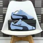 Sneakers/loafers in light blue and black, perfect for driving or everyday wear. Puma's signature logo adds a touch of style and quality.
